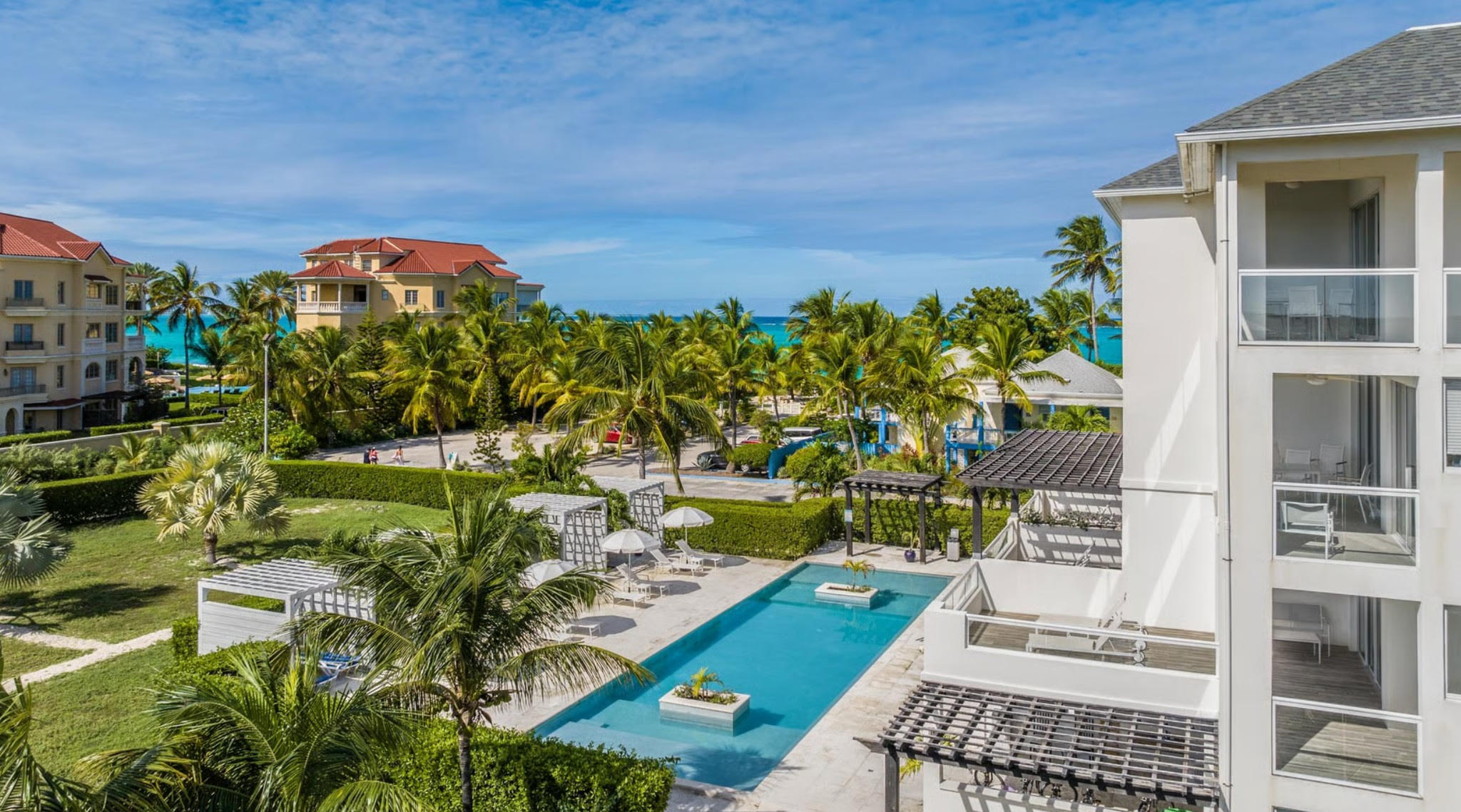The Tides Grace Bay aerial view showing pool, property exterior and proximity to Grace Bay Beach in Turks and Caicos